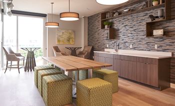 A modern kitchen with a wooden table and chairs.